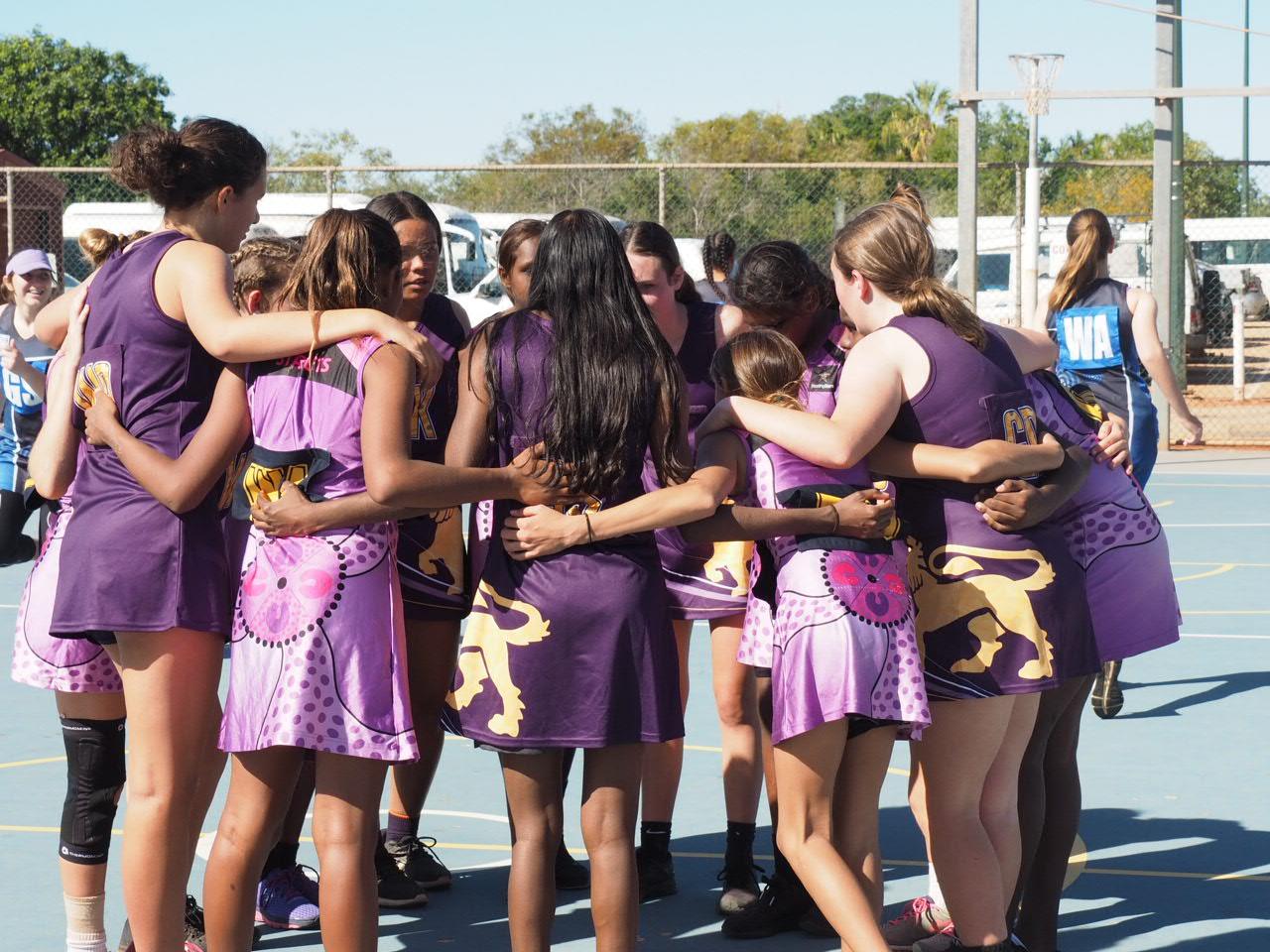 Girls sport team huddle