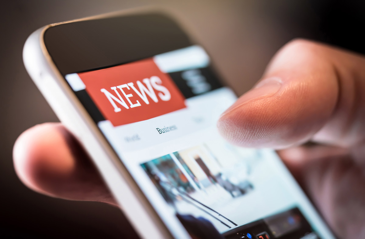 Close up of a mobile phone with the news on the screen